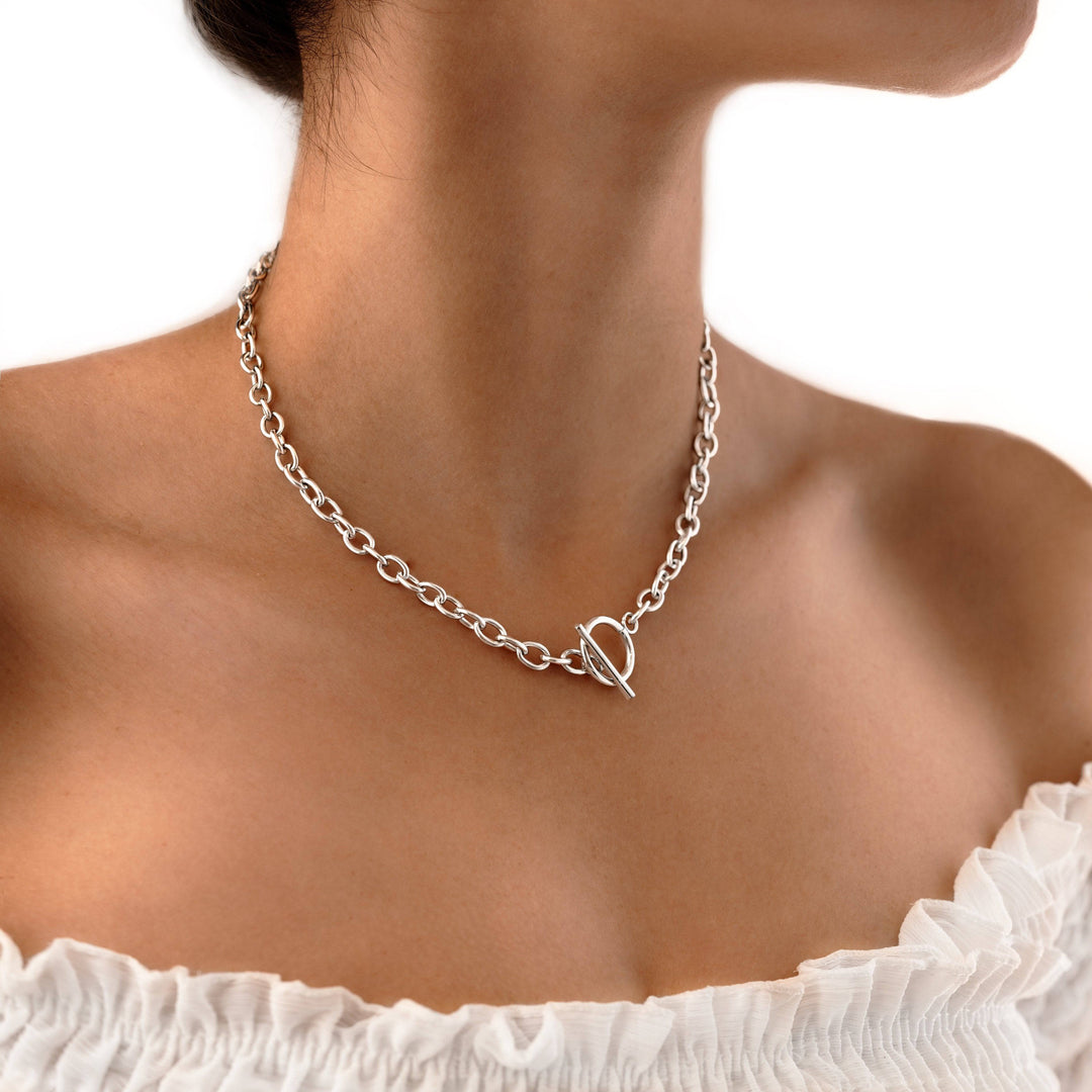 Women's minimalist geometric necklace, available in gold-plated or sterling silver, featuring a modern delicate design.