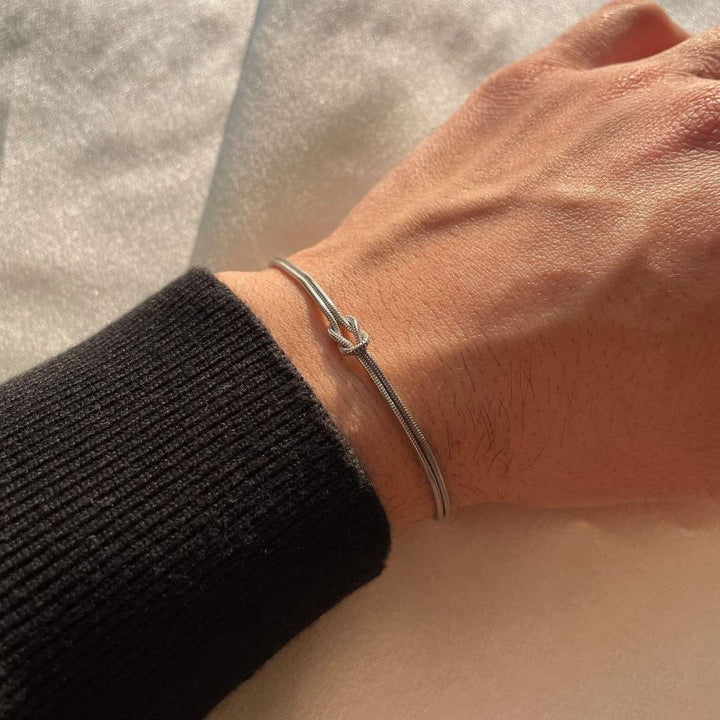 Feminine gold minimalist knot bracelet, ideal for understated style.