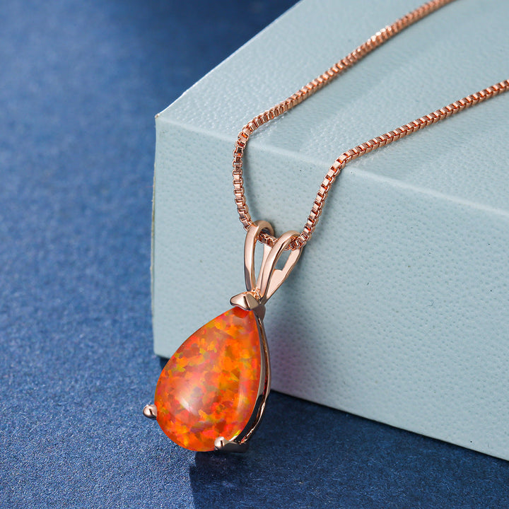 Close-up of minimalist opal drop pendant necklace. Captivating gemstone in a rose gold setting.