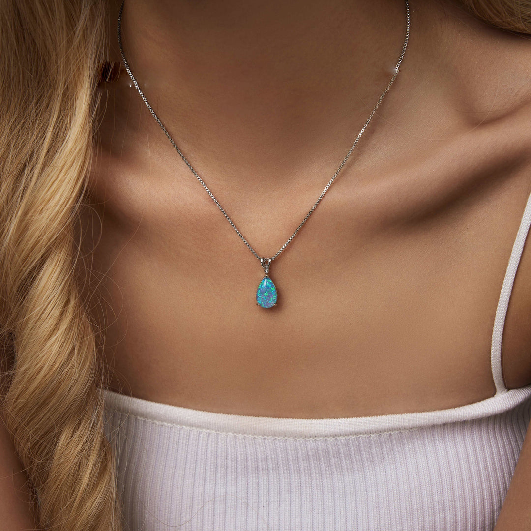 Rose gold opal drop pendant necklace for women. Minimalist style, features a captivating gemstone.