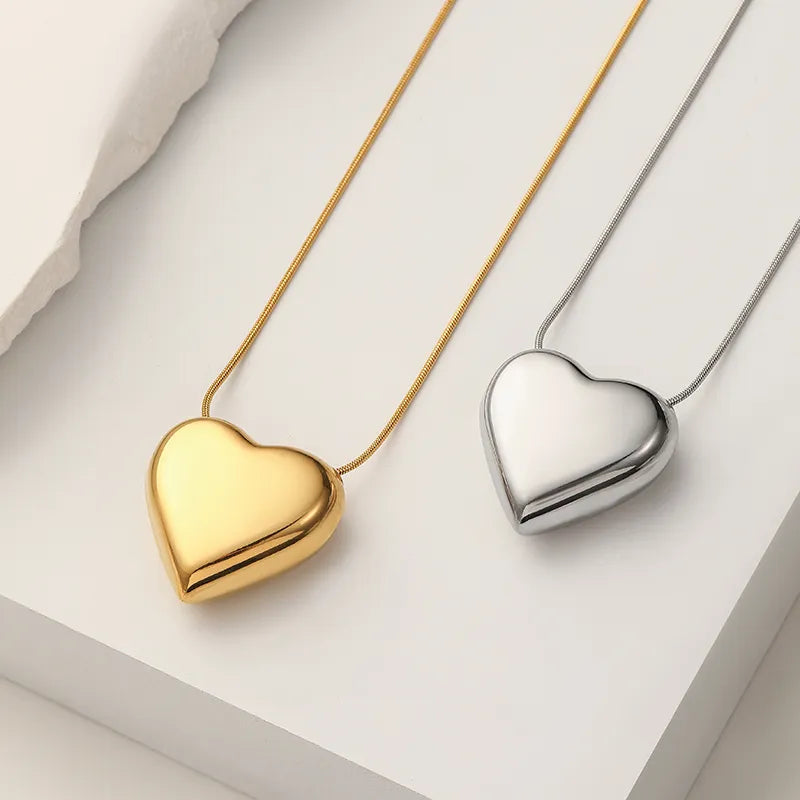 Delicate women's peach heart pendant necklace. Minimalist stainless steel, a stylish and simple fashion accessory.