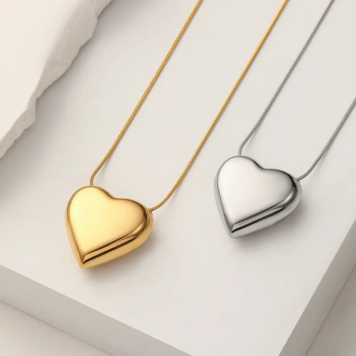Delicate women's peach heart pendant necklace. Minimalist stainless steel, a stylish and simple fashion accessory.