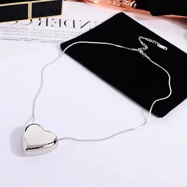 Women's minimalist heart pendant necklace. Simple, elegant, and delicate stainless steel fashion accessory for everyday.