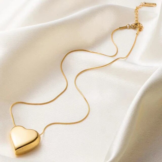 Polished stainless steel minimalist heart pendant necklace. Simple, elegant women's jewelry, delicate design.