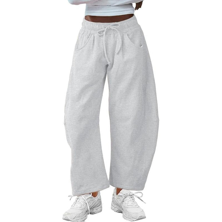 Modern women's barrel-leg pants with a relaxed fit and drawstring waist, offering comfortable, chic style.