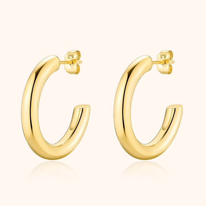 Women's modern half-round hoop earrings in sterling silver, a minimalist and elegant everyday jewelry choice.