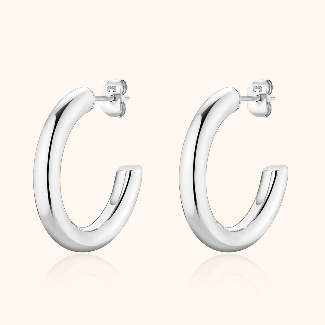 Minimalist half-round hoop earrings for women, crafted from sterling silver with a sleek modern appeal.