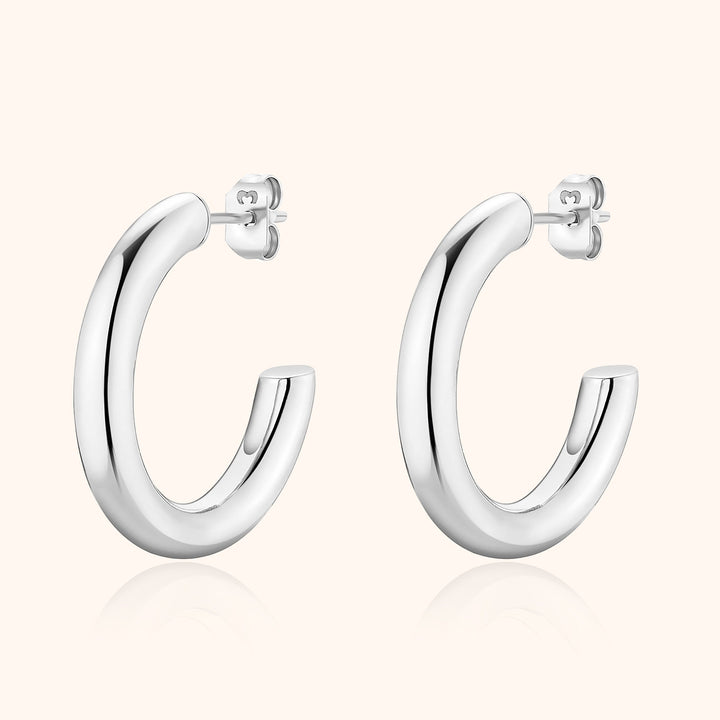 Minimalist half-round hoop earrings for women, crafted from sterling silver with a sleek modern appeal.