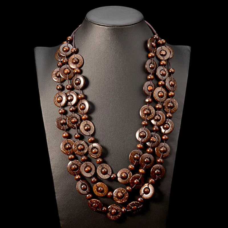 Close-up of women's bohemian multi-layered wooden bead necklace, showing natural textures.