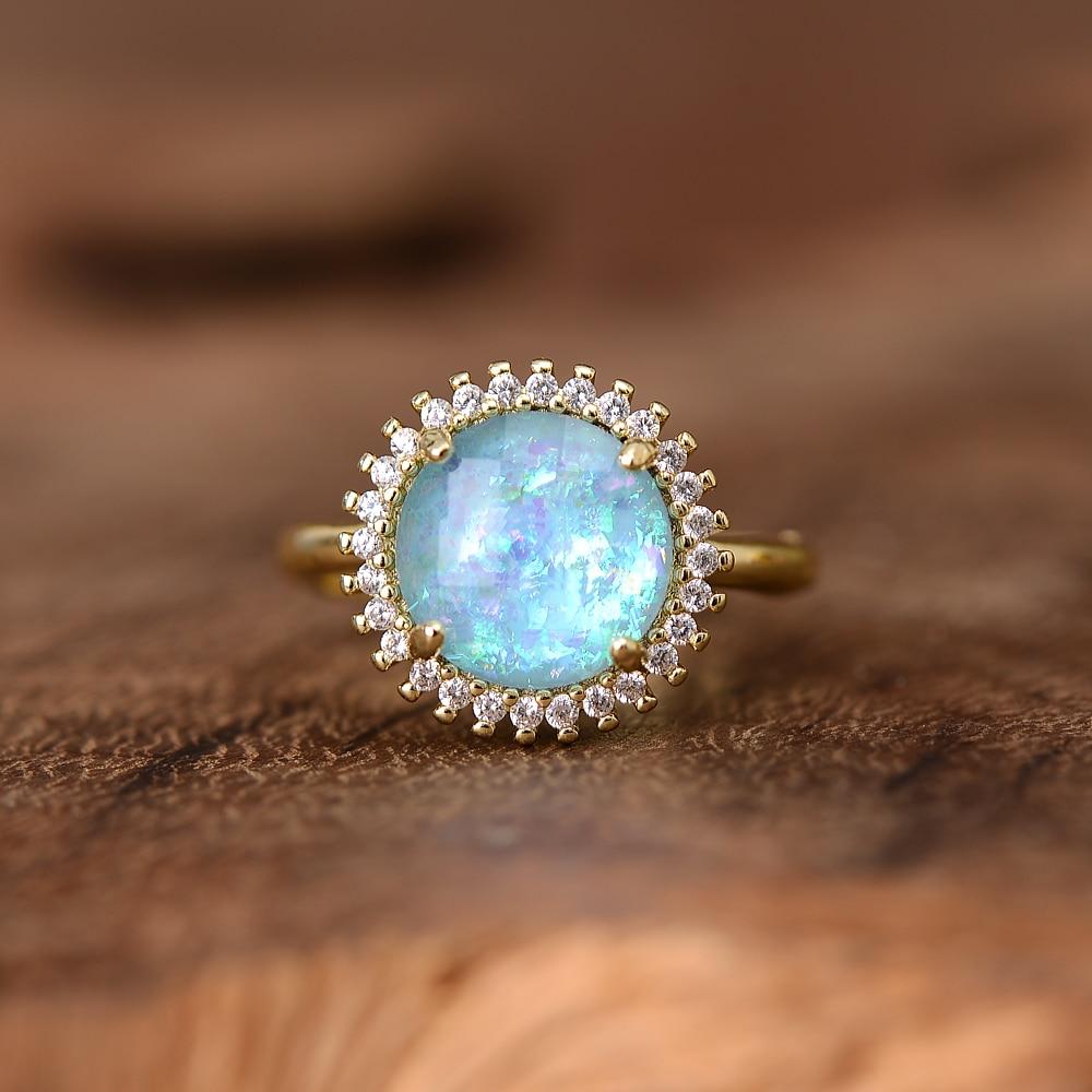 Handmade women's cocktail ring featuring a captivating blue opal, offering a mystical glow.
