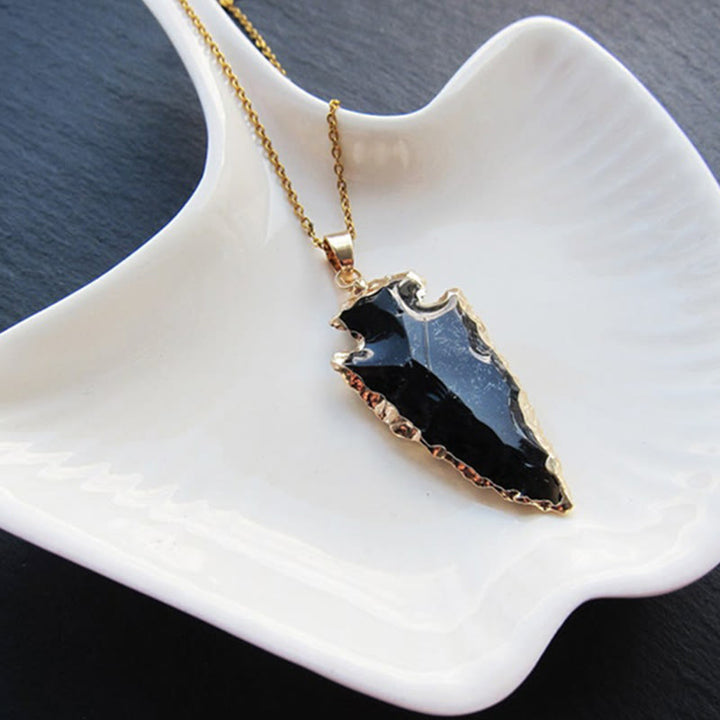 Assorted crystal arrowhead pendant necklaces for women: Amethyst, Rose Quartz, Obsidian.