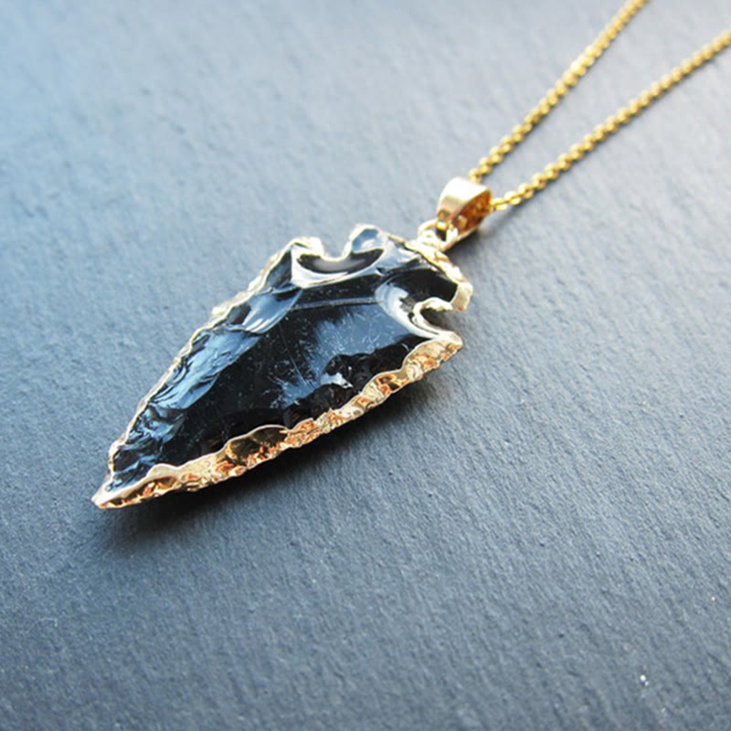 Elegant women's arrowhead pendant necklace with natural crystal. Spiritual energy jewelry.