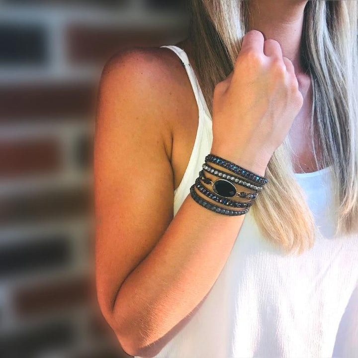 Detailed view of a handmade women's natural onyx and quartz wrap bracelet, adjustable and featuring healing stones.