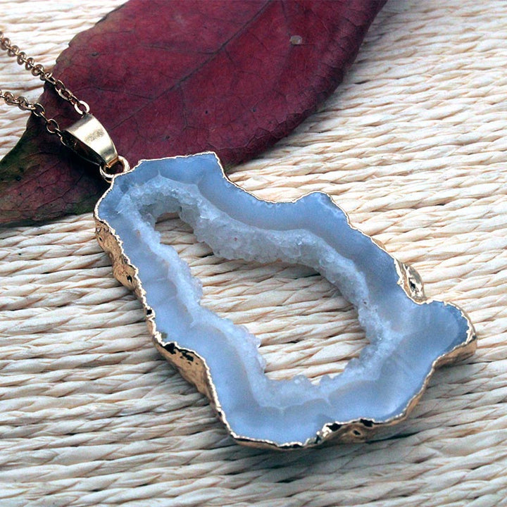 Women's 'Gaia' pendant, featuring a raw natural geode crystal in a sterling silver setting. Geode jewelry.