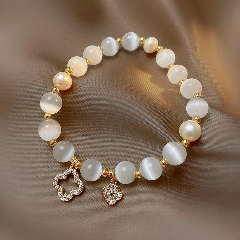 Elegant women's bracelet with natural crystal, lustrous pearls, & gold-plated chain. Adjustable, spiritual jewelry.
