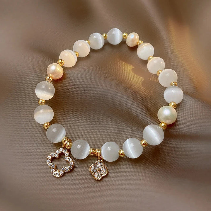 Elegant women's bracelet with natural crystal, lustrous pearls, & gold-plated chain. Adjustable, spiritual jewelry.