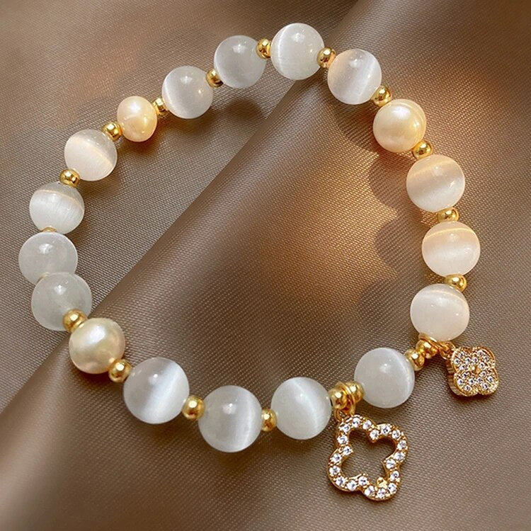 Spiritual women's healing bracelet featuring natural crystals, pearls, & a delicate gold plated adjustable chain.