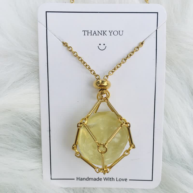 Gold women's necklace with a natural healing crystal pendant. Stylish gemstone.