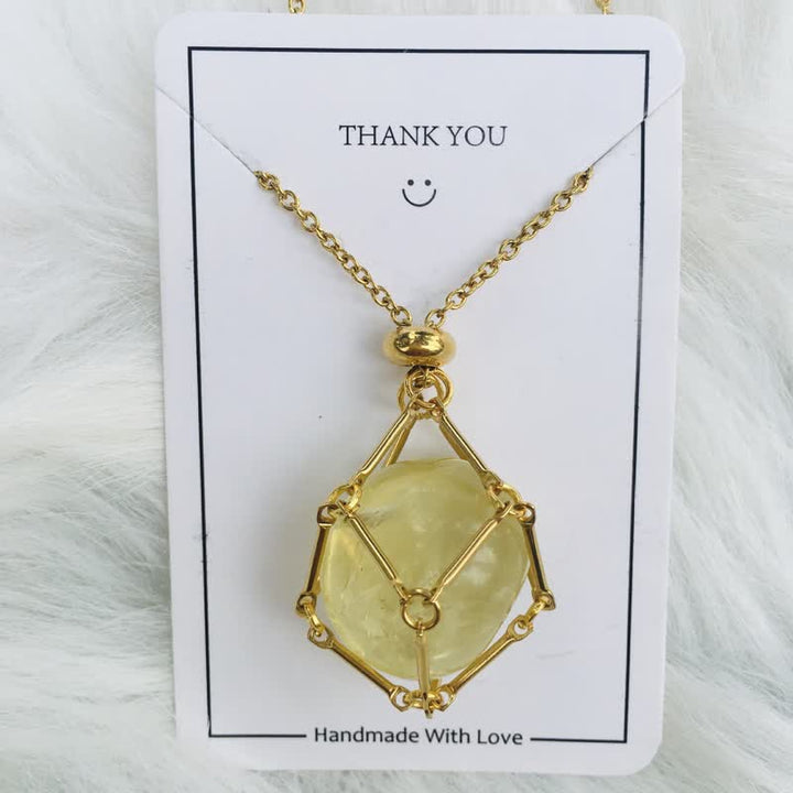 Gold women's necklace with a natural healing crystal pendant. Stylish gemstone.