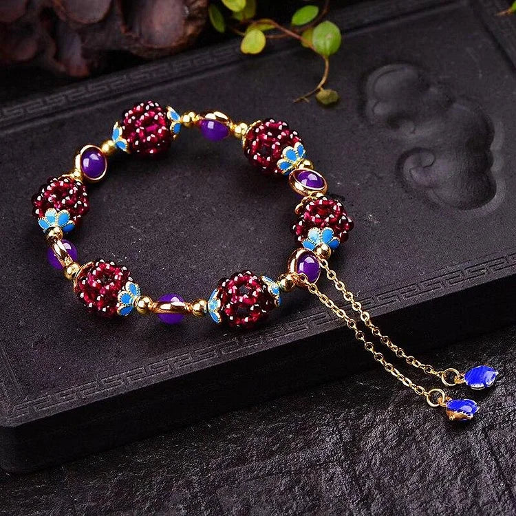 Elegant women's bracelet with polished natural garnet stones, a vibrant and healing gemstone jewelry accessory.