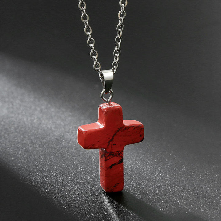 Stylish women's natural stone cross pendant, a versatile spiritual fashion accessory.