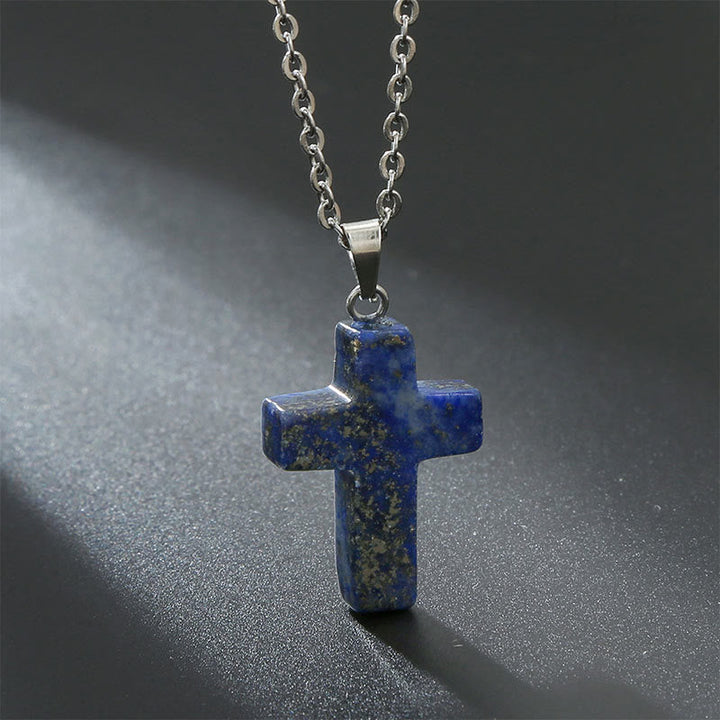 Artistic shot of women's natural stone cross pendant, emphasizing spiritual beauty.
