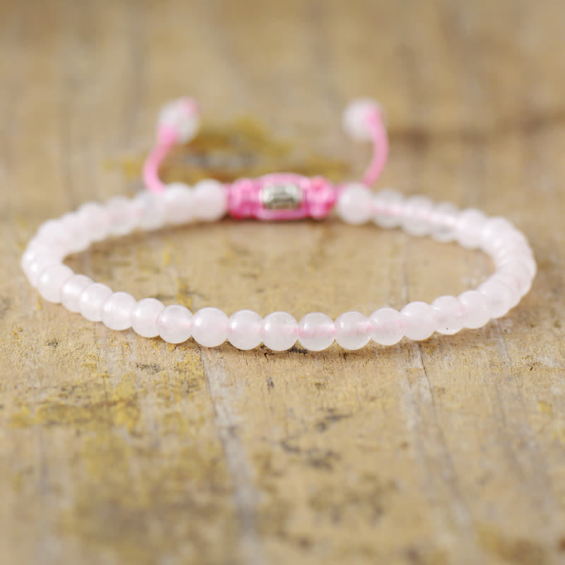Detailed view of the adjustable braided clasp on a women's natural stone & pearl bracelet.