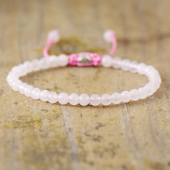 Detailed view of the adjustable braided clasp on a women's natural stone & pearl bracelet.
