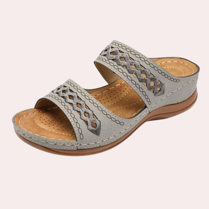 Closeup of women's sandals showcasing non-slip sole and arch support technology