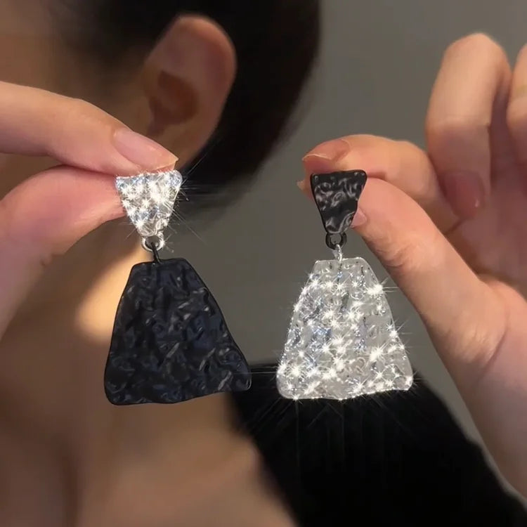 Close-up of Nora Magma Texture Statement Earrings, highlighting the unique black and white textured surface.