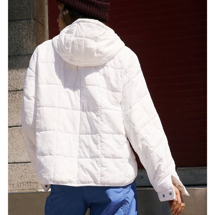 Woman comfortably wearing Noria pullover puffer jacket, showcasing its casual style & warmth.