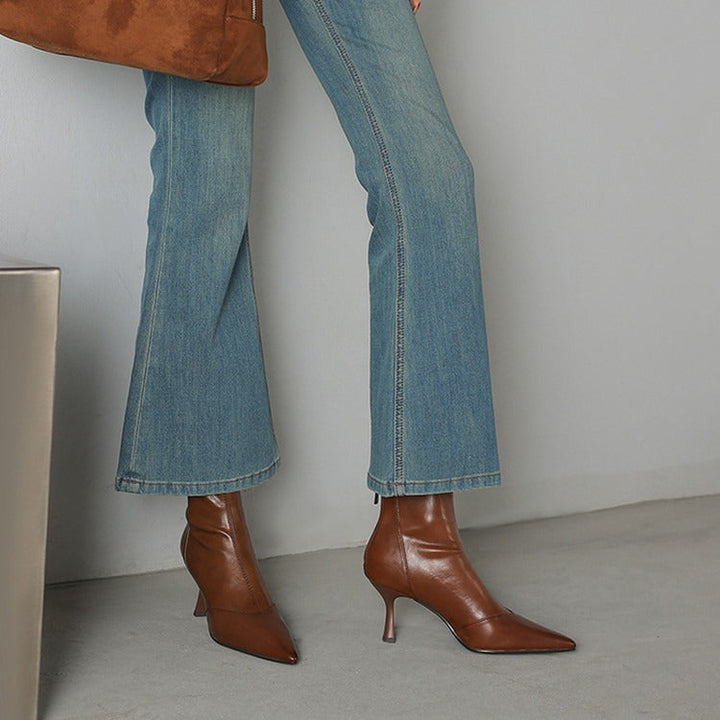 Chic black NOVA ankle boots for women, featuring elegant pointed toe heels. Fashionable women's shoes.