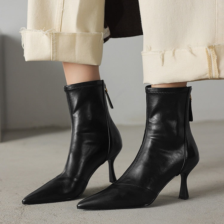 Confident strides in black NOVA pointed toe ankle boots with heels. Stylish & versatile women's footwear.