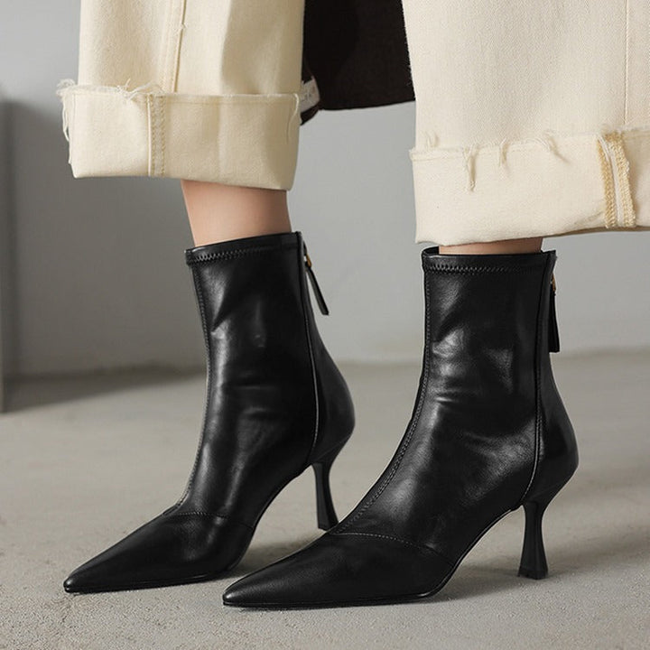 Confident strides in black NOVA pointed toe ankle boots with heels. Stylish & versatile women's footwear.