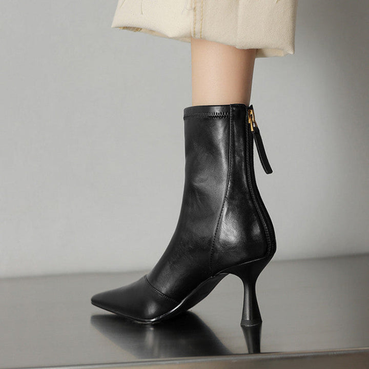 Sleek black NOVA pointed toe ankle boots with comfortable heels. Stylish women's fashion footwear.