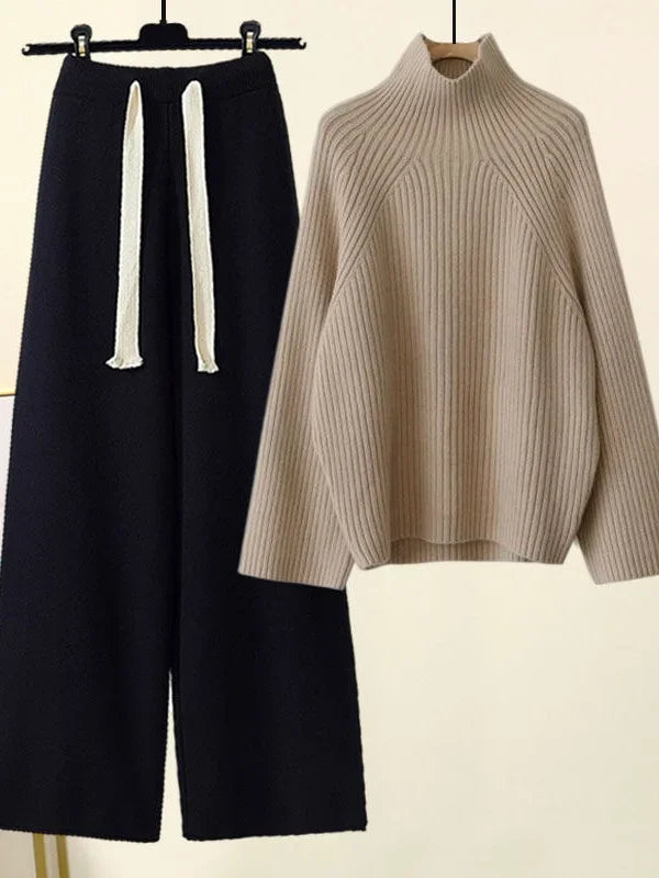 Soft women's knit two-piece lounge set: cozy oversized sweater and comfortable wide-leg pants for leisure wear.