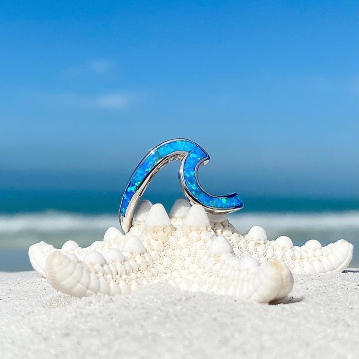 Stunning silver wave ring for women, featuring a vibrant opal gem and ocean-inspired design.