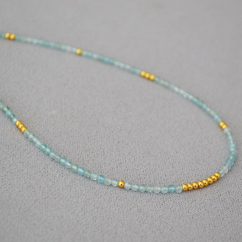 Women's Ocean Whisper clavicle necklace with delicate blue beads, elegant and adjustable.