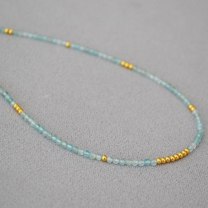 Women's Ocean Whisper clavicle necklace with delicate blue beads, elegant and adjustable.