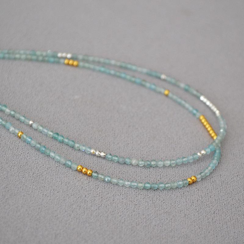 Adjustable Ocean Whisper clavicle necklace with vibrant blue beads, a stunning accessory.