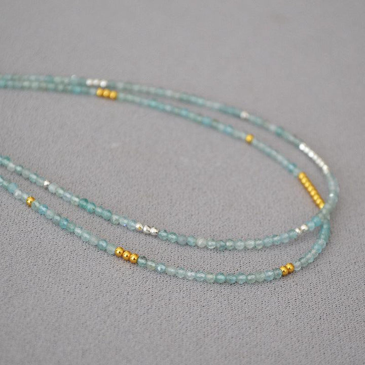 Adjustable Ocean Whisper clavicle necklace with vibrant blue beads, a stunning accessory.