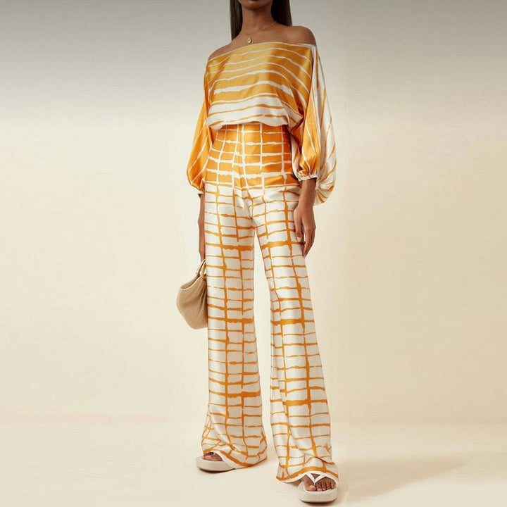 Women's vacation wear: printed one-shoulder co-ord set with wide-leg pants. Perfect trendy spring outfit.