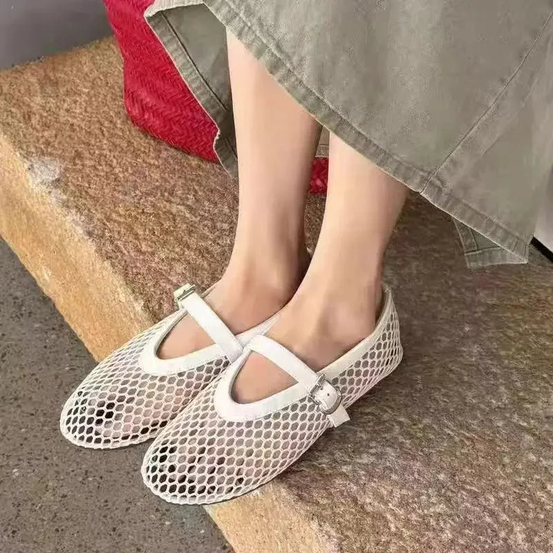 Slip-on women's open-weave Mary Jane flats. Breathable design ensures comfortable, lightweight summer wear.