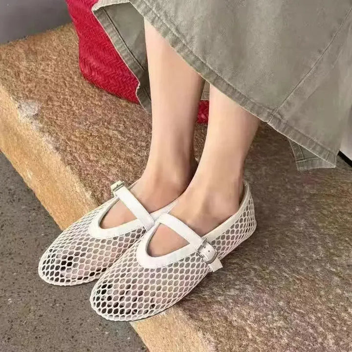 Slip-on women's open-weave Mary Jane flats. Breathable design ensures comfortable, lightweight summer wear.