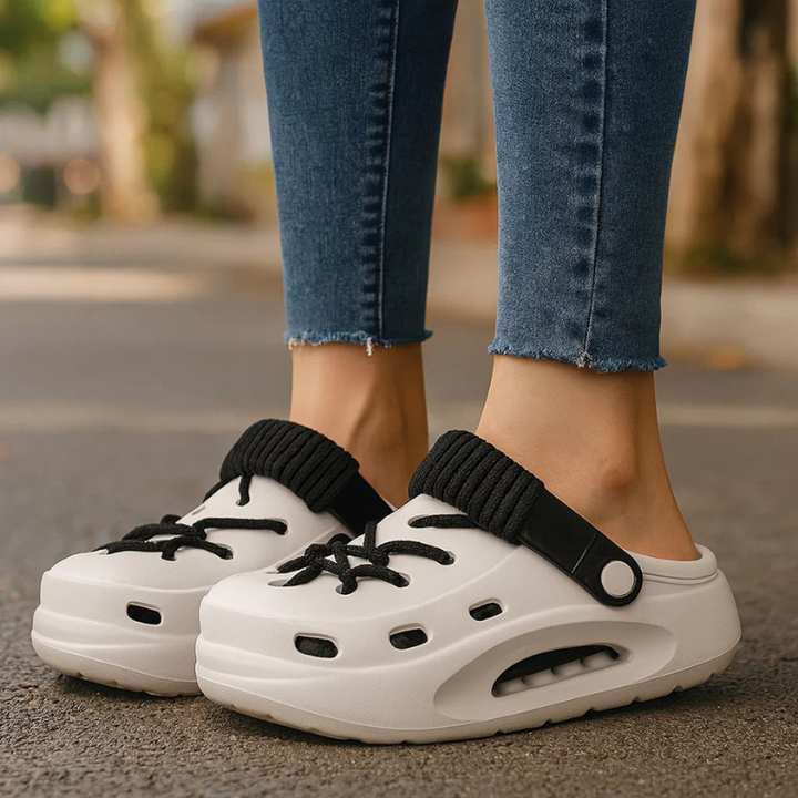 Close-up of Women's Orbit Laced Clogs, highlighting breathable material & distinctive laces.