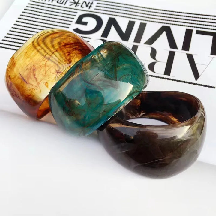 Women's organic marble irregular bangle bracelet, a sculptural acrylic jewelry accessory with a unique pattern.