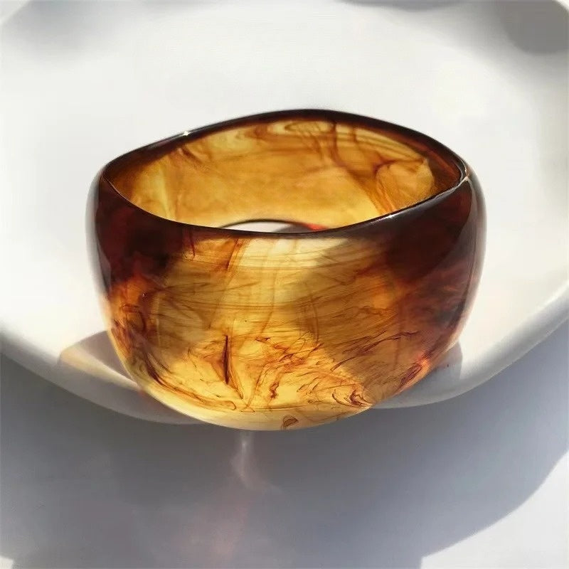 Stylish women's irregular marble bangle bracelet, a lightweight sculptural acrylic accessory for modern outfits.