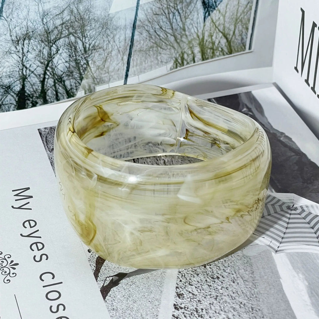 Detailed view of a women's irregular bangle bracelet, showcasing its intricate organic marble acrylic pattern.
