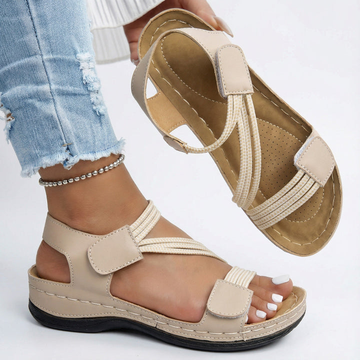 Model wearing women's adjustable comfort sandals, showing casual style & supportive arch for walking.