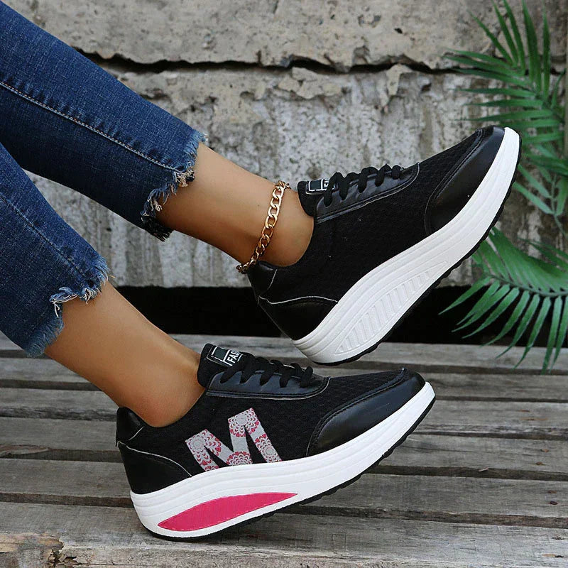 Interior of women's orthopedic sneakers, emphasizing cushioned comfort & dedicated arch support for pain relief.